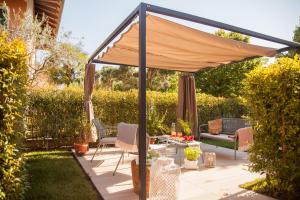 a canopy over a patio in a garden at La Casa di Giò in Caorle