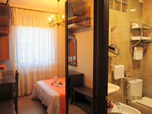 łazienka z łóżkiem, umywalką i prysznicem w obiekcie Hotel Playa Samil Vigo w mieście Vigo