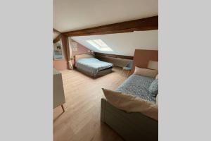 Cette chambre comprend 2 lits et un canapé. dans l'établissement La BOUGERIE de Chaligny à 15 min de Nancy, à Chaligny