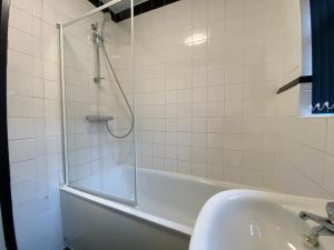 a bathroom with a shower and a tub and a sink at Ruskin Place by SG Property Group in Crewe +13 photos