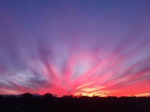 The sunrise or sunset as seen from the country house or nearby