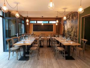 a dining room with long tables and chairs at HOTEL RESTAURANT CIRIUS in Montrond-les-Bains