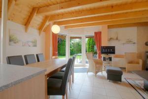 a kitchen and dining room with a table and chairs at Strandvogt 3 NT3 in Dorum Neufeld