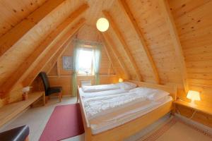 a bedroom with a bed in a wooden cabin at Strandvogt 3 NT3 in Dorum-Neufeld