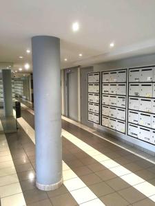 a room with a column and lockers in a building at Studio BRITTANY in Chambéry