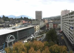 a city with buildings and a street with cars at Studio BRITTANY in Chambéry