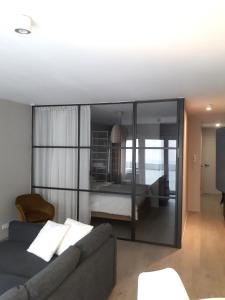 een woonkamer met een bank en een bed bij Ostend Central Residence in Oostende