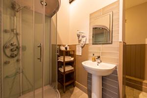 a bathroom with a sink and a shower at Swan Hotel in Wotton under Edge