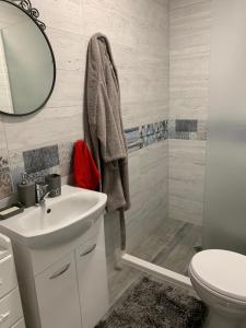 a bathroom with a white sink and a mirror at Апартамент Сливен in Sliven