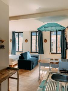 a living room with a couch and a table at La villa des souhaits in Honfleur