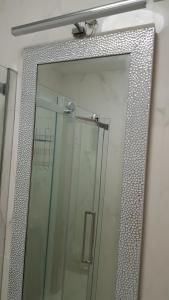 a shower with a mirror in a bathroom at Villa Maja in Omišalj