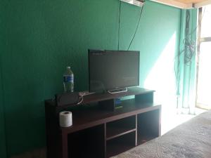 a tv sitting on a stand in a bedroom at Suit compartida con amenidades in Mexico City