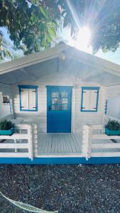 a small white house with a blue door at Manu B&B in Murighiol