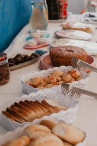 a table topped with different types of pastries and cakes at Pousada Aluá in Porto Seguro