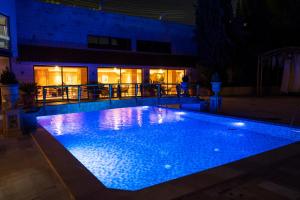 a swimming pool lit up at night at Amman International Hotel in Amman