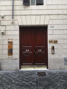 a large wooden door on the side of a building at Frattina FF italian suites in Rome