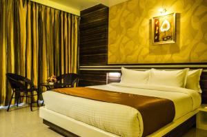 a bedroom with a large bed in a room at Rudra Shelter International Hotel in Vasai