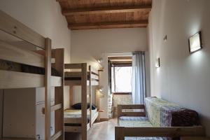 a room with two bunk beds and a window at Parga Natura Alojamiento in Parga