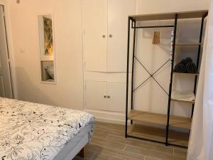 a bedroom with a bed and a glass closet at Chez Tom - au pied des musées in Grasse