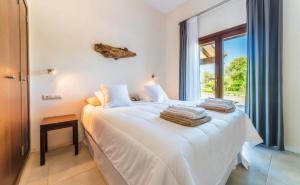 Posteľ alebo postele v izbe v ubytovaní Villa Son Sard