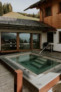 a swimming pool in the backyard of a house at Mountain Chalet Pia in La Valle