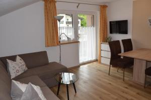 een woonkamer met een bank en een tafel bij Haus Regenbogen in Pertisau