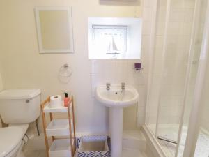 a bathroom with a sink and a toilet and a shower at Stable Cottage Llandudno in Llandudno +9 photos