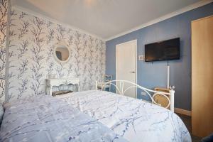 a bedroom with a bed and a tv on the wall at Host & Stay - Stonehaven in Seaton Carew +9 photos
