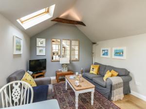 ein Wohnzimmer mit Sofa und Tisch in der Unterkunft Little Brook in Broadwey