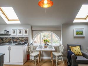 a kitchen and dining room with a table and chairs at Little Brook in Broadwey