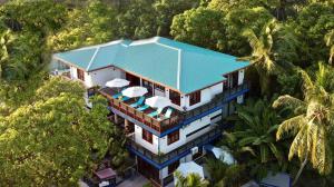 an aerial view of a house with a blue roof at Zero Degree Residence in Fuvahmulah