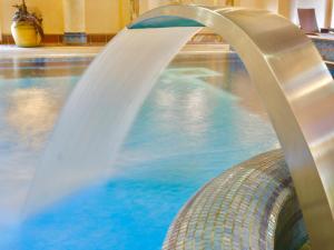 a water slide in a swimming pool at SPA Hotel Jawor in Jaworze