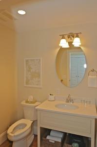 a bathroom with a toilet and a sink and a mirror at Publick House Historic Inn and Country Motor Lodge in Sturbridge