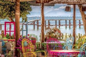 a table and chairs with a view of a pier at Myrto Guesthouse in Kavos