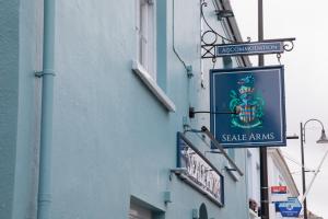 a sign on the side of a building at The Seale Arms in Dartmouth