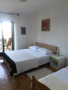Postel nebo postele na pokoji v ubytování Apartments Tamara