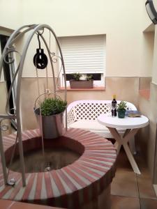 a room with a table and a potted plant at Casa María in Málaga