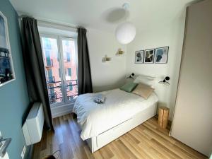 ein kleines Schlafzimmer mit einem Bett und einem Fenster in der Unterkunft Sunny and calm 2 bed apartment place du Pin in Nizza