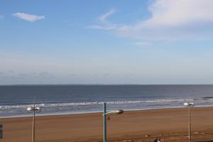 a view of a beach with the ocean and lights at Studio Front de Mer in Saint-Jean-de-Monts +1 photo