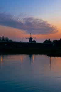 a large body of water with a lighthouse at Pillows Luxury Boutique Hotel aan de IJssel in Deventer