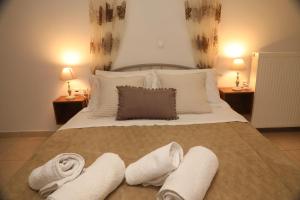 a bedroom with a large bed with towels on it at Xigia Escape villas in Khartáta