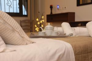 a bed with a tray with a tea set on it at Xigia Escape villas in Khartáta