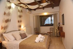 a bedroom with a bed with towels on it at Xigia Escape villas in Khartáta