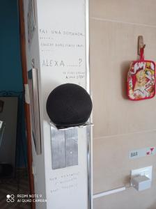 a black stool sitting next to a wall with a bag at Bed & Breakfast da Charlie in LʼAquila