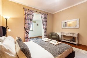 a bedroom with a large bed and a fireplace at Privilege Casa da Videira with Swimming Pool, Quelfes - Olhão in Olhão