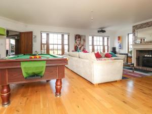 a living room with a pool table and a couch at Pendle View in Blackburn