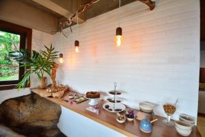 a room with a counter with various items on it at Villa Gardena Suites in Praia do Rosa