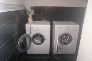 a washing machine and a washer in a bathroom at Cozy apartment in Ialysos
