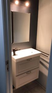 
a white toilet sitting in a bathroom next to a sink at Residentie Da Vinci Middelkerke in Middelkerke
