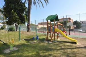 a playground with a slide in a park at RNET - IR 7-29 Studios Roses Costa Brava in Roses